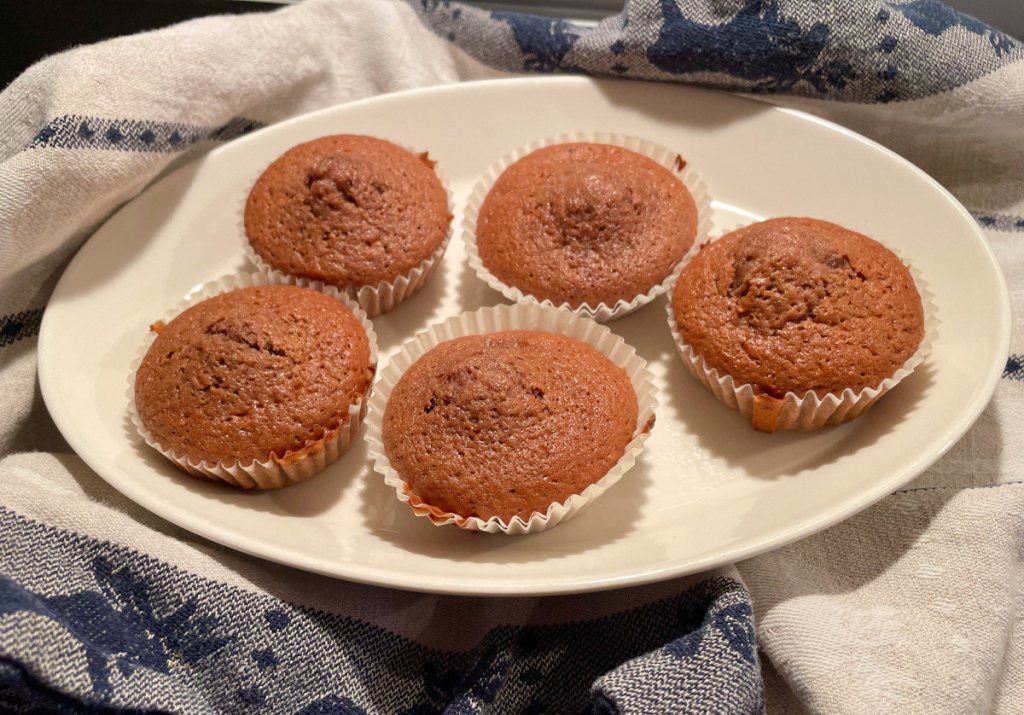Banana cocoa muffins on a plate.